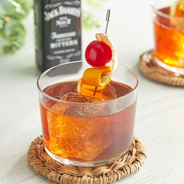 A glass of Jack Daniel's Tennessee Bitters with a cherry on top.