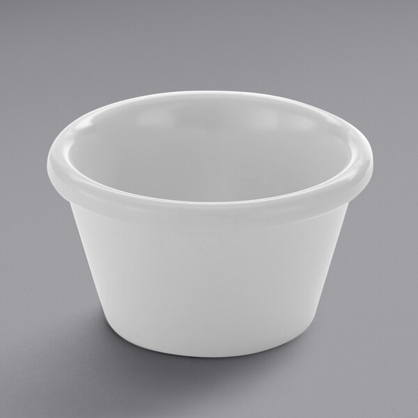 An American Metalcraft white melamine ramekin on a gray surface.