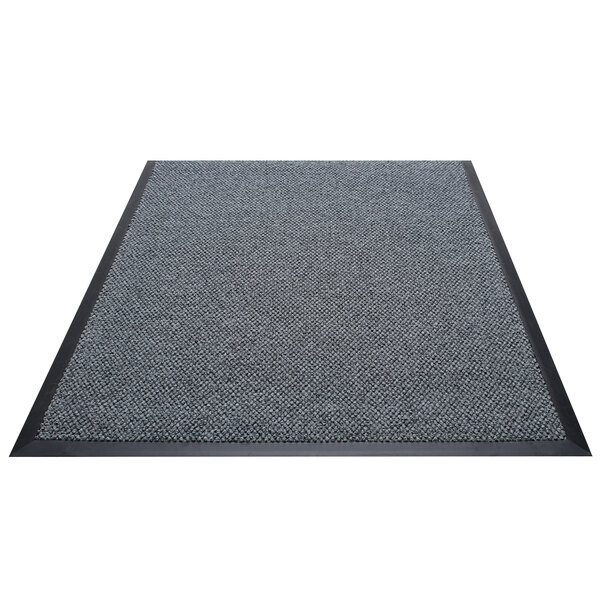 A grey Berber carpet with black rubber border.