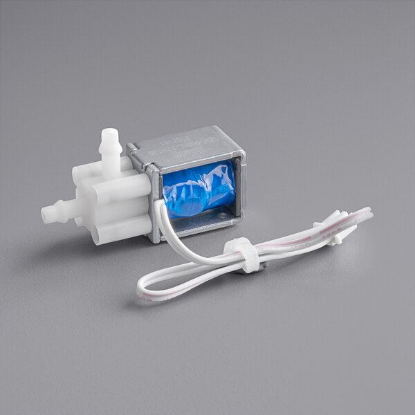 A close-up of a blue and white VacPak-It solenoid valve.