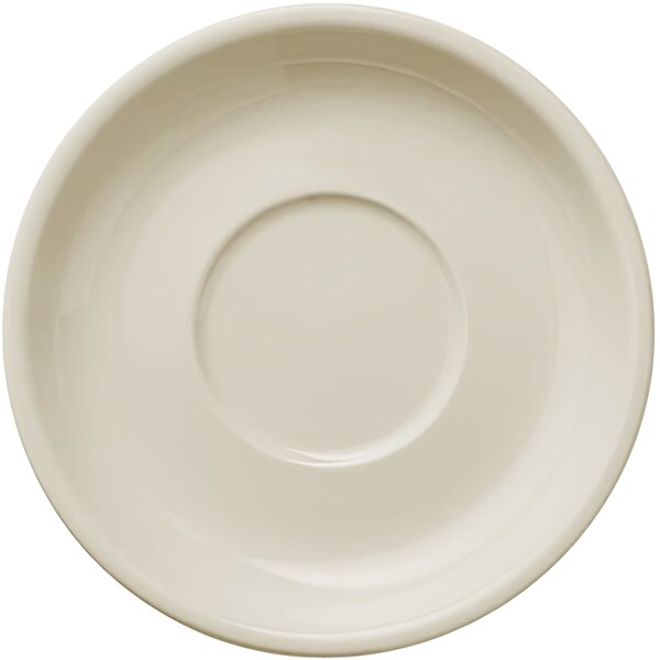 A Libbey Porcelana cream white saucer with a circular edge.