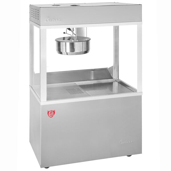 A silver Cretors floor model popcorn popper with a bowl on top.