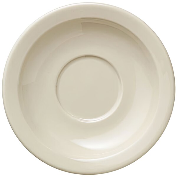 A Libbey Porcelana Cream white porcelain saucer with a circular edge.