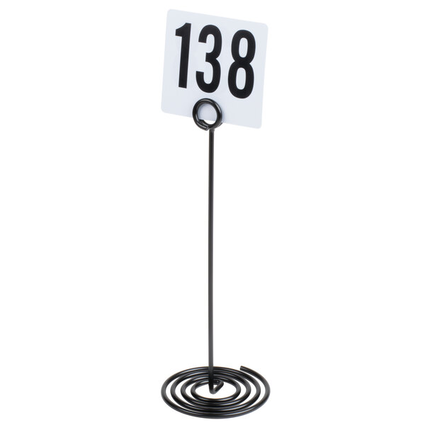 An American Metalcraft black metal swirl base table card holder with a number on it.