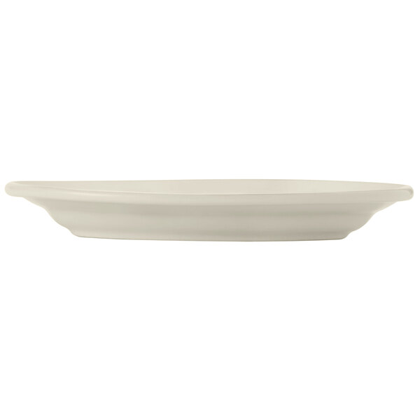 A Libbey Porcelana cream white porcelain platter with a wide rim.