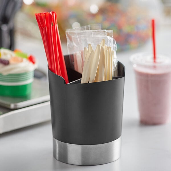 a black cup with red and white straws in it