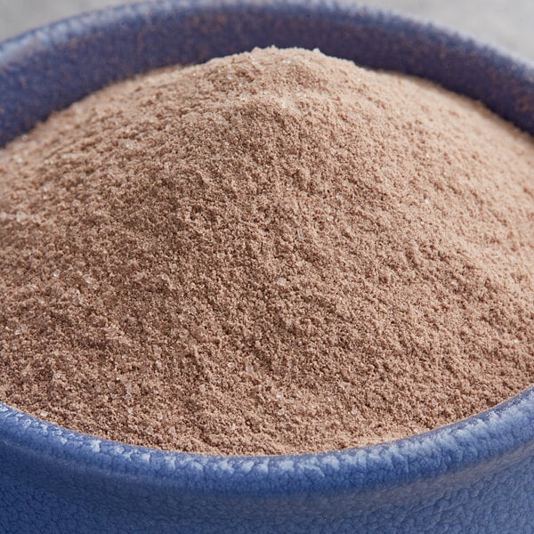 A blue bowl filled with UPOURIA Mexican Spice hot chocolate mix powder.