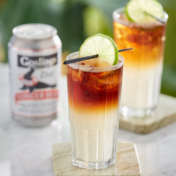 A glass of Goslings Diet Ginger Beer with a straw and a lime slice.