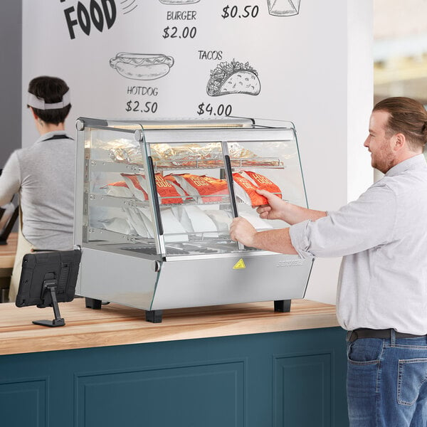 a man holding a bag of chips in a display case