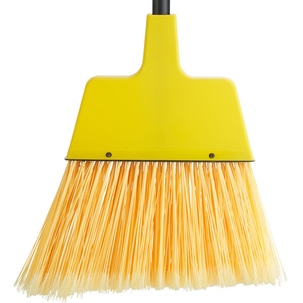 A yellow Choice 10" Economy Angled Broom with long bristles.