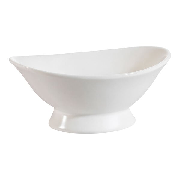 A CAC bone white porcelain oval bowl with a foot.