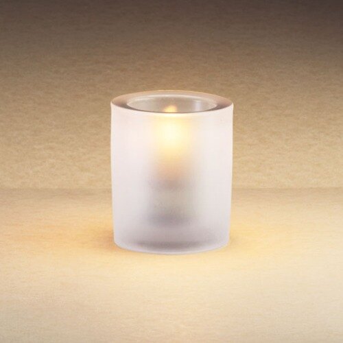 A Sterno Frost Mini Bubbles liquid candle holder with a lit candle inside.