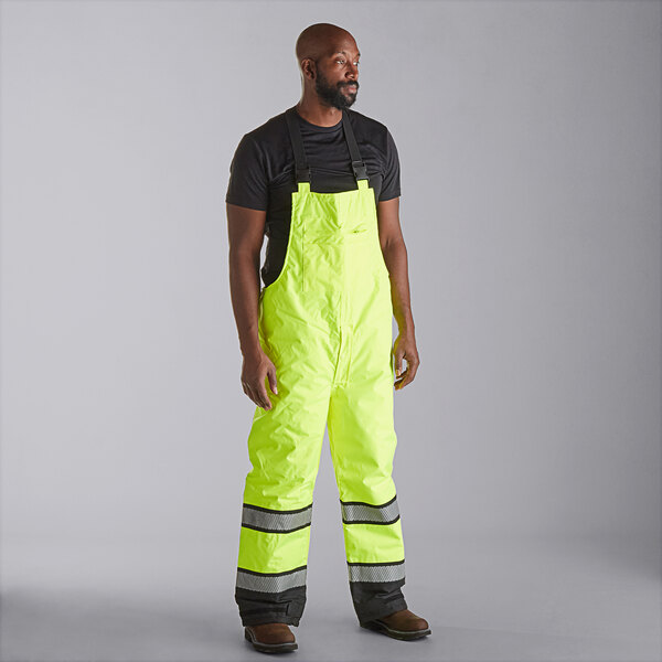 A man wearing Cordova Hi-Vis yellow quilted bib pants.