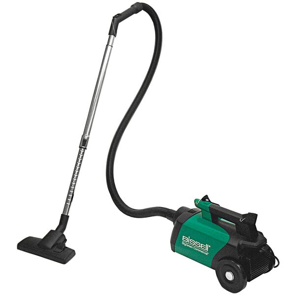 A Bissell commercial green and black cordless canister vacuum with a long tube.