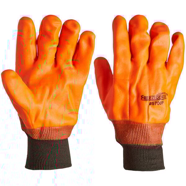 A pair of orange Cordova warehouse gloves with black and orange wrist bands.