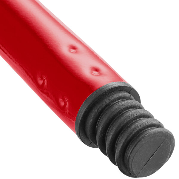A close up of a red tube with black caps on it.