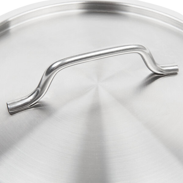 A close-up of a Vollrath stainless steel pan cover with a metal bar handle.