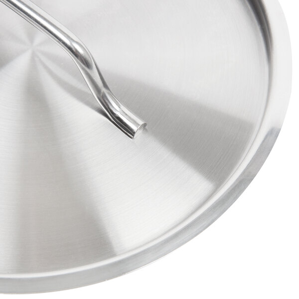 A Vollrath stainless steel pan cover with a metal handle.