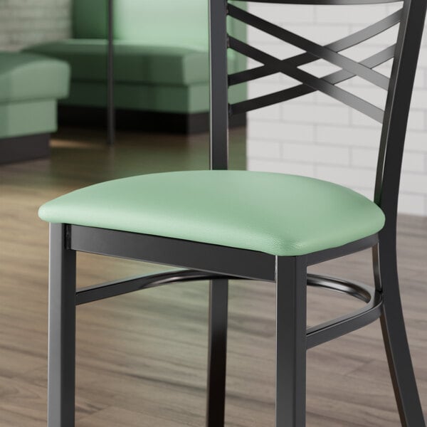 A Lancaster Table & Seating seafoam green vinyl padded seat for metal frame seating.