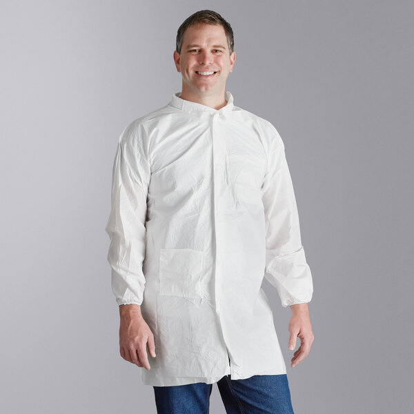 A man in a white Malt Impact lab coat with elastic wrists smiling.