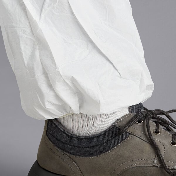 A person wearing white Malt ProMax coveralls with white shoes.