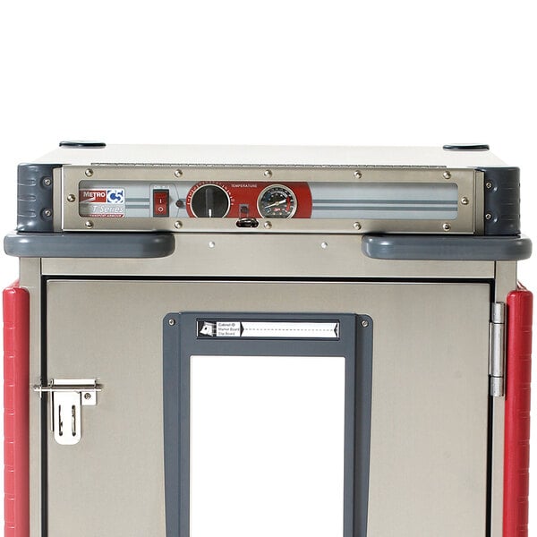 A close-up of a Metro T Series holding cabinet with a red door and handle.