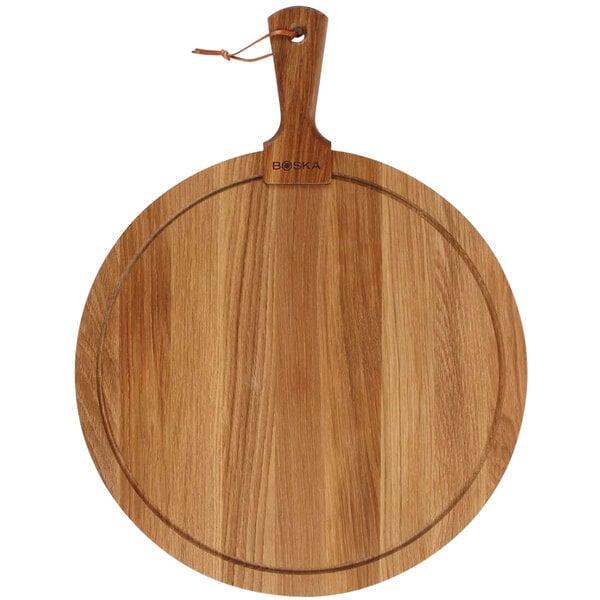 A Boska round European oak serving board with a handle.