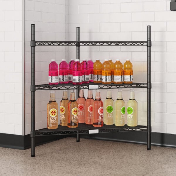 A Regency black wire triangle shelf kit with bottles of liquid on it.