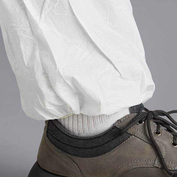 A person wearing white Malt ProMax coveralls with white shoes.