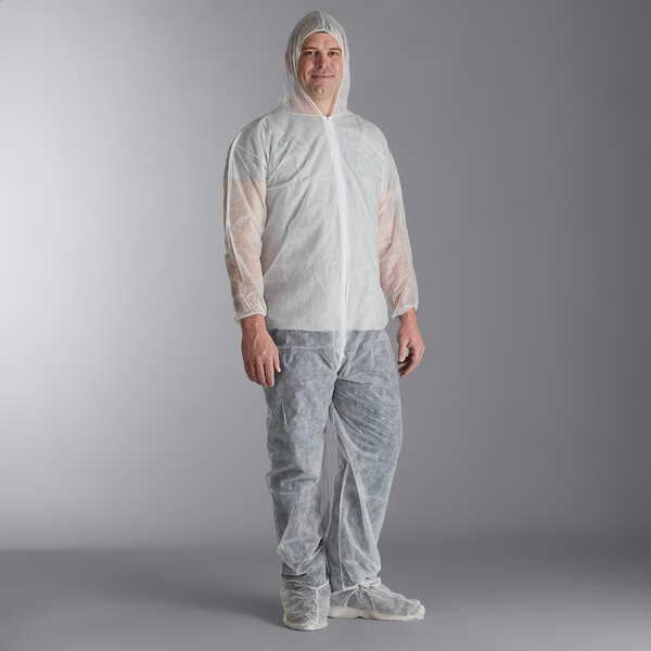 A man wearing a white protective suit with attached boots and hood.
