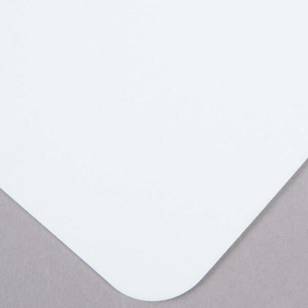 A white Tablecraft flexible cutting board with a small square on it.