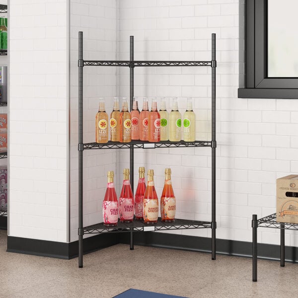 A black Regency wire shelf with bottles of liquid on it.