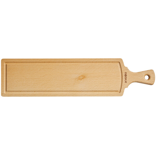 A Boska beech wood serving board with a handle.