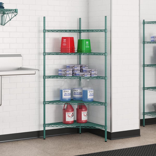 A green Regency wire shelving unit with red and blue containers on shelves.