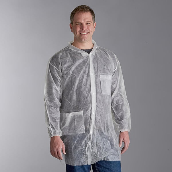 A man wearing a white Malt Impact lab coat smiling.