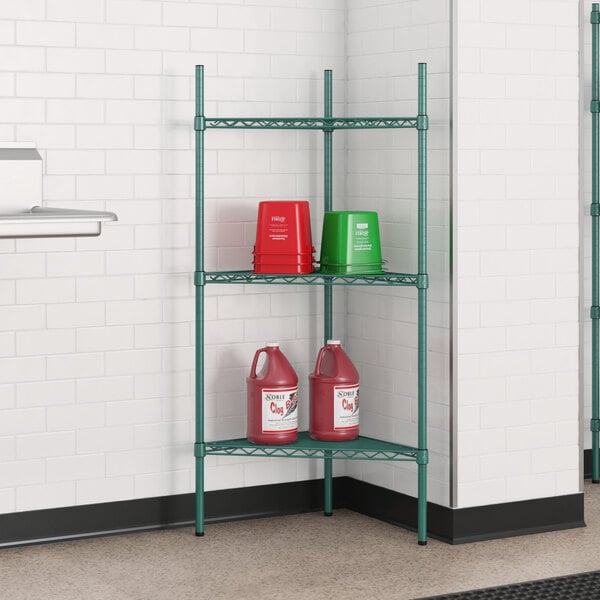 A green Regency wire shelf with red and green containers on it.