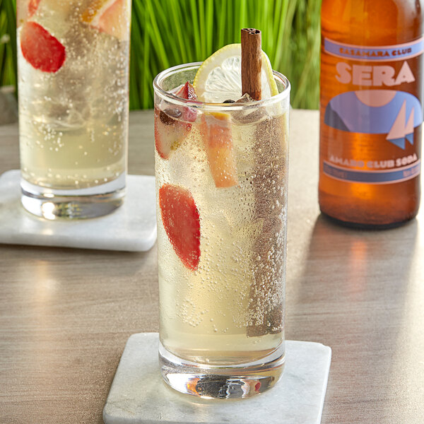 A glass of Casamara Club Sera Afterglow soda with a strawberry in it.