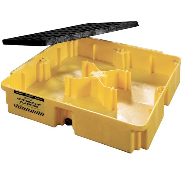 A yellow plastic spill containment platform with a black surface.