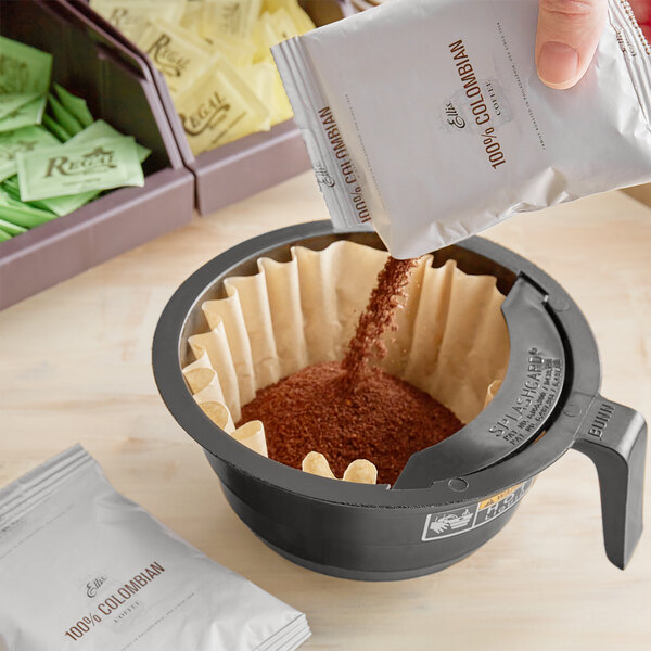 A person pouring Ellis Colombian coffee into a filter.