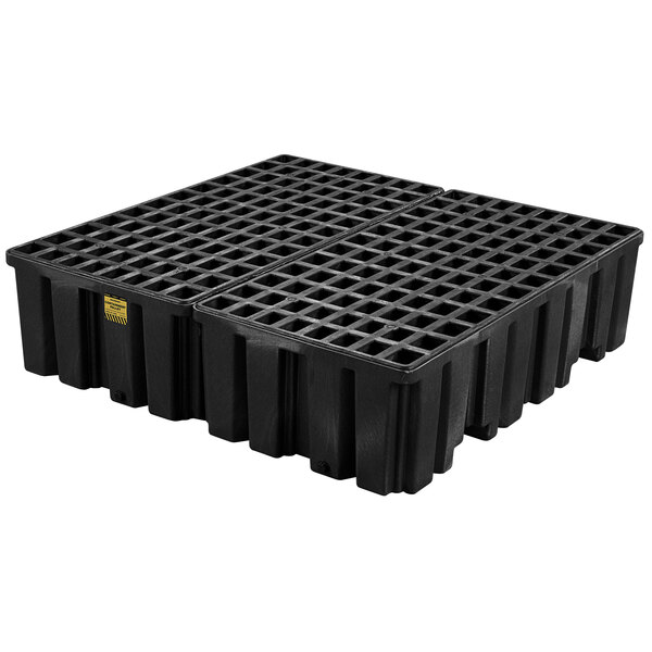 A black plastic Eagle Manufacturing drum pallet with four squares and drain holes.