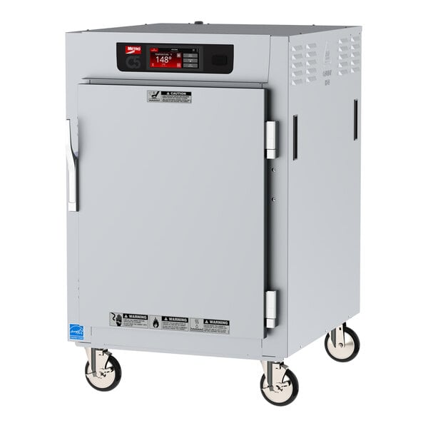 A white Metro C5 series heated holding cabinet with wheels and a solid door.