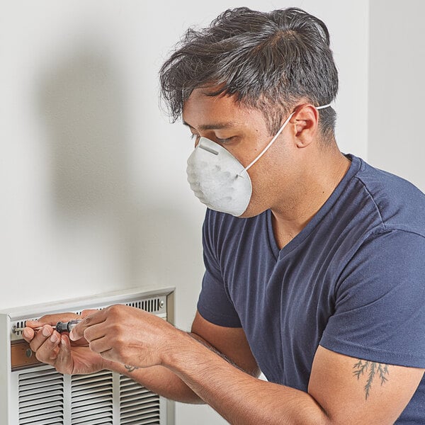 A man wearing a Honeywell face mask while working.