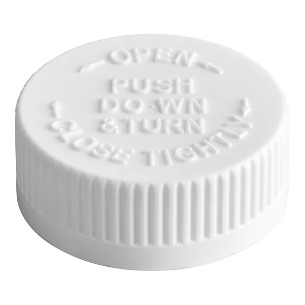 A white child-resistant bottle cap with ribbed sides and embossed instruction text.