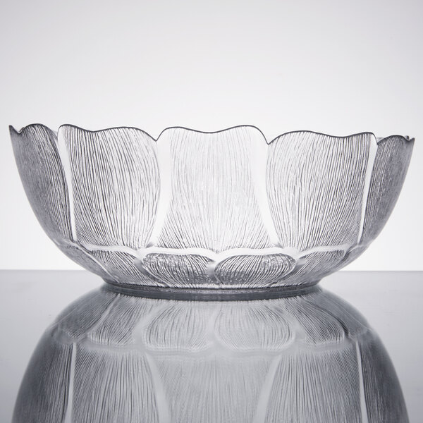 A clear Arcoroc glass bowl with a pattern on it.