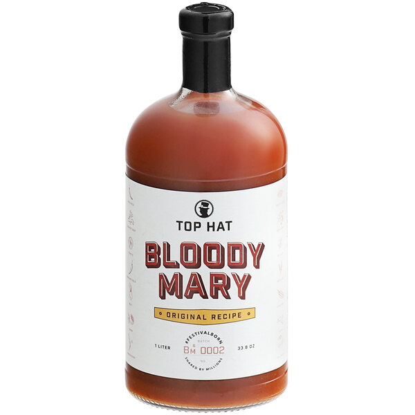 A bottle of Top Hat Provisions Bloody Mary Mix with a white label on a table in a cocktail bar.