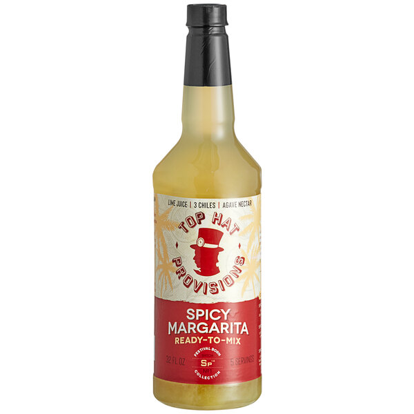 A case of Top Hat Provisions Spicy Margarita Mix on a table in a cocktail bar.