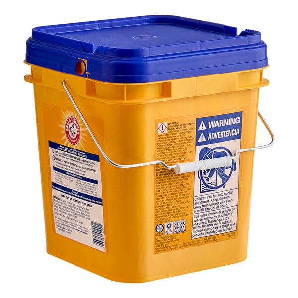 A yellow bucket with blue handles and a blue lid containing Arm & Hammer Crisp Clean HE Powder Laundry Detergent.