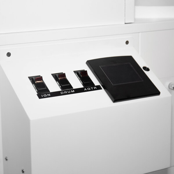 A white Primo coffee roaster with switches and a black rectangular panel.