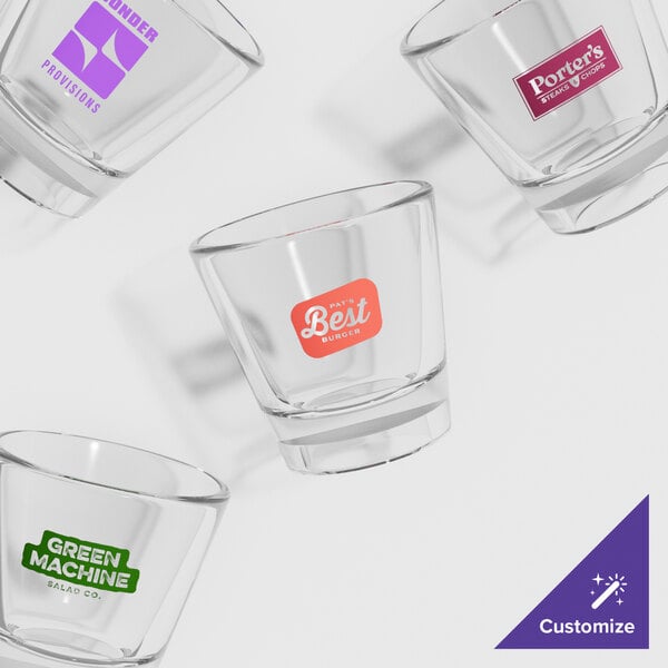 A clear GET plastic shot glass with a green logo.