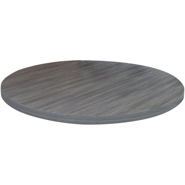 An American Tables & Seating round light gray faux wood laminate table top on a table.